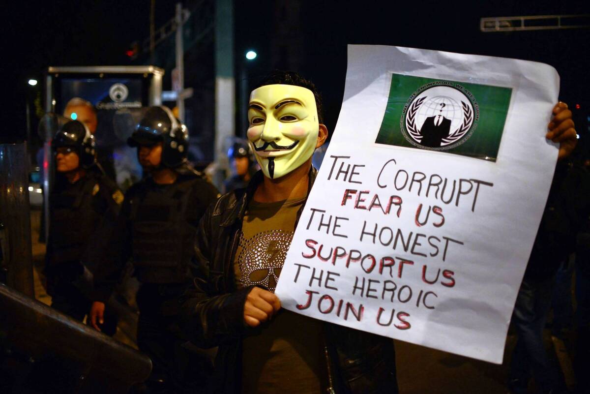A protester in a Guy Fawkes mask takes part in a Mexico City demonstration against government corruption.