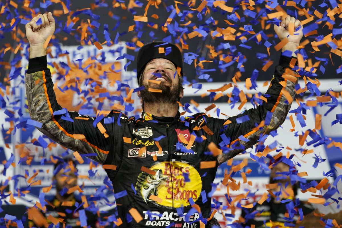 Martin Truex Jr., celebrates winning the NASCAR Cup series auto race in Richmond, Va., Saturday, Sept. 11, 2021. (AP Photo/Steve Helber)