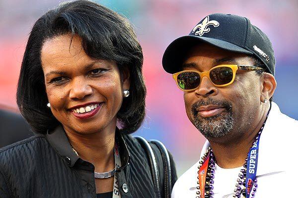 Former Secretary of State Condoleezza Rice, left, and film director Spike Lee watch warmups on the field before the start of Super Bowl XLIV between New Orleans and Indianapolis. The Saints won, 31-17.