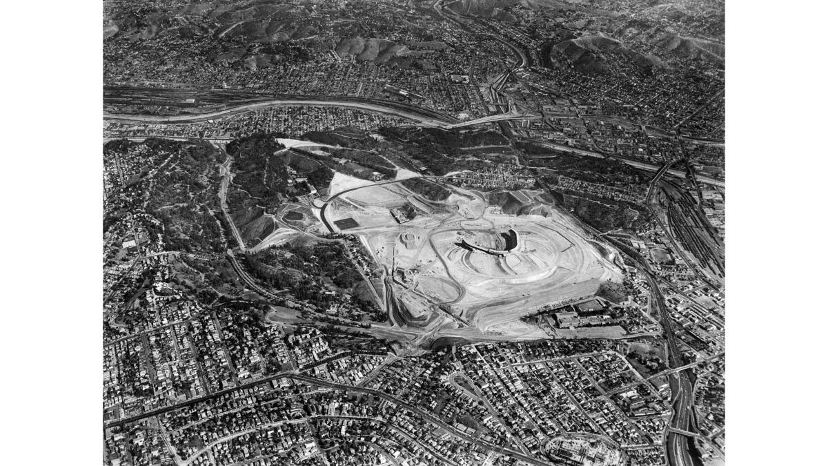 1961 aerial photo of construction of Dodger Stadium and the neighborhoods around Chavez Ravine. Interstate 5 runs horizontally through the image.