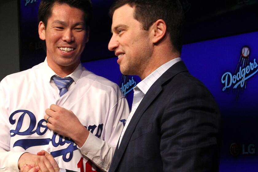 Recently signed pitcher Kenta Maeda is introduced to reporters by Andrew Friedman, the Dodgers' president of baseball operations, during a news conference Thursday.