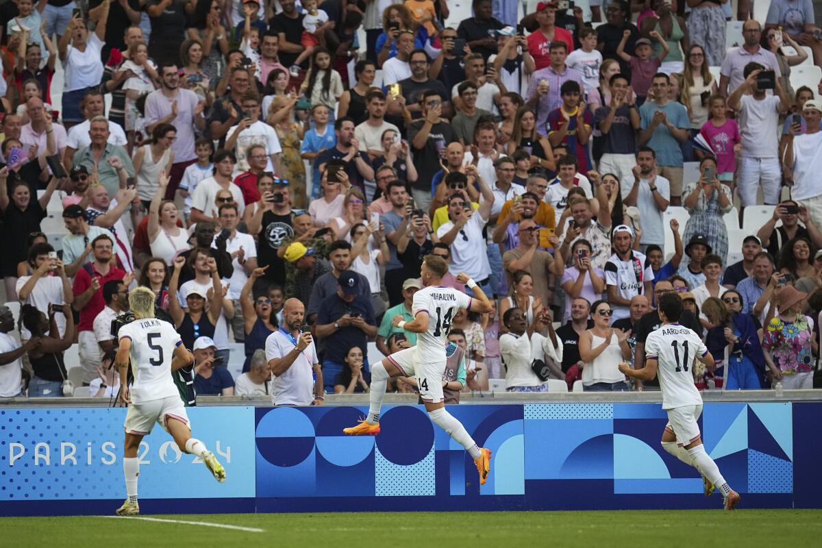 American Djordje Mihailovic, center, celebrates after scoring his side's first goal during an Olympics group stage win 