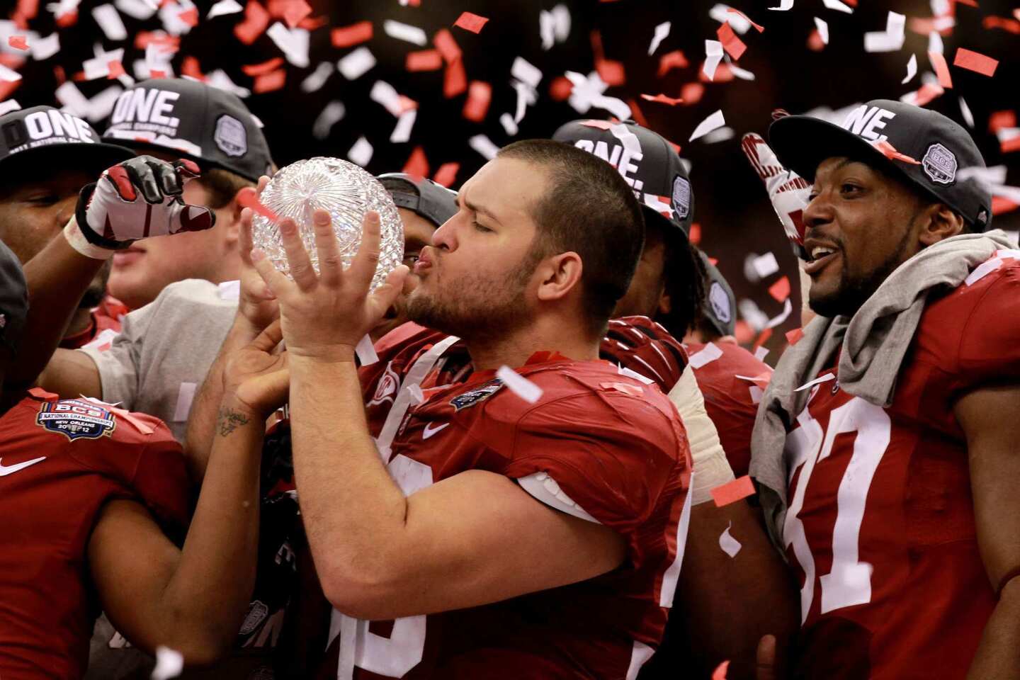 Alabama defensive lineman Nick Gentry gives the BCS trophy a kiss after helping the Crimson Tide shut down LSU, 21-0, in the championship game on Monday night at the Superdome in New Orleans.