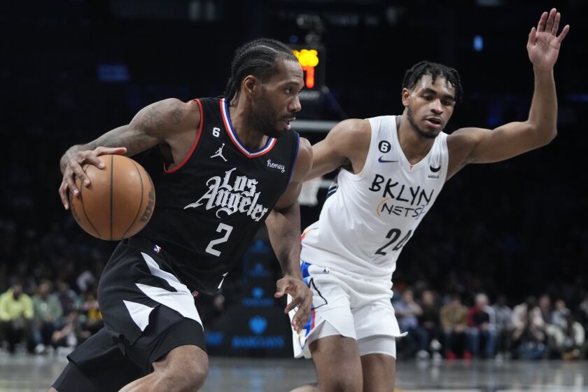 Los Angeles Clippers' Kawhi Leonard (2) drives past Brooklyn Nets' Cam Thomas (24) during the second half of an NBA basketball game, Monday, Feb. 6, 2023, in New York. The Clippers won 124-116. (AP Photo/Frank Franklin II)