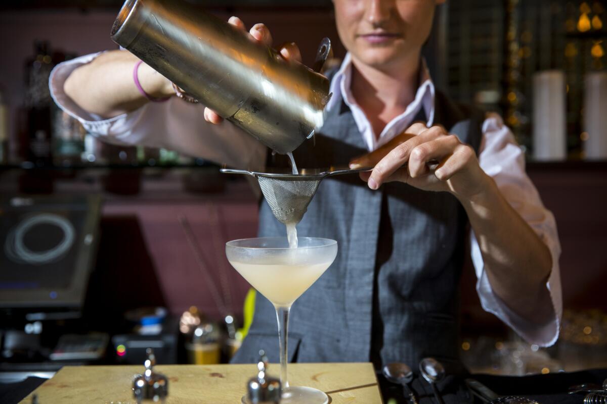 According to a new survey, 70% of millennials would date a mixologist. Pictured is a bartender from Providence in Los Angeles making a drink.
