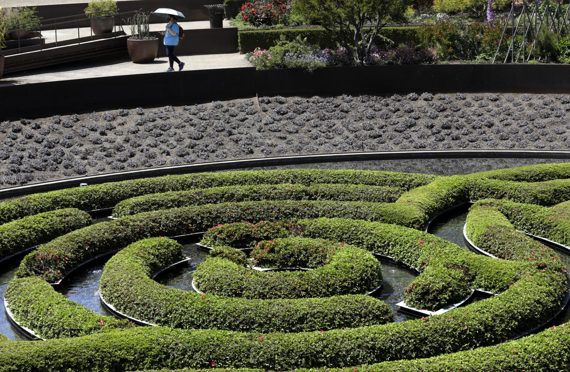 Jennifer Conway, top, walks in the garden at the Getty Center. 