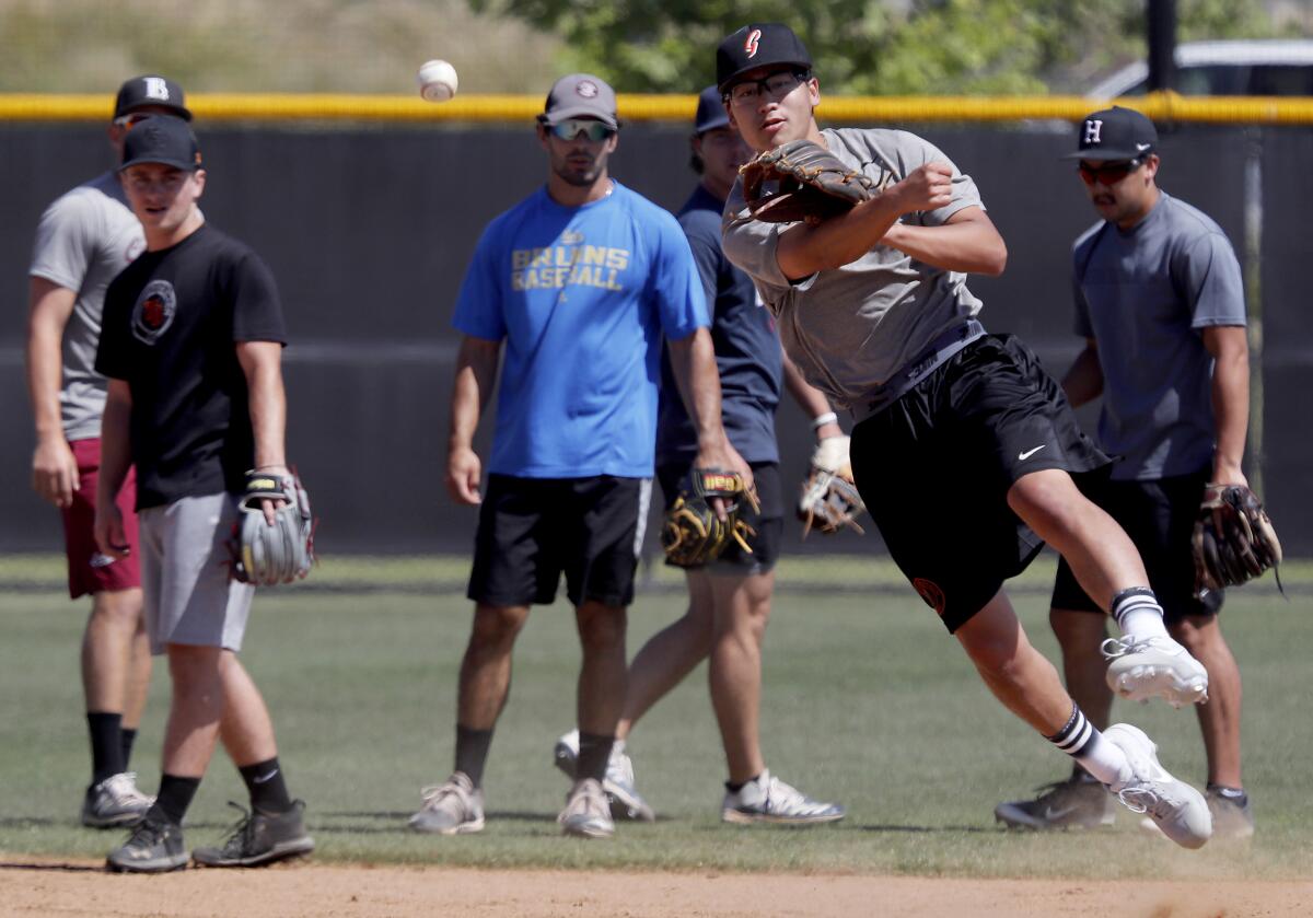 Minor league players work out at a field in Irvine.