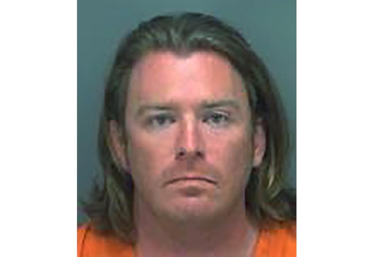 A booking photo shows Adam Johnson of Parrish, Fla.