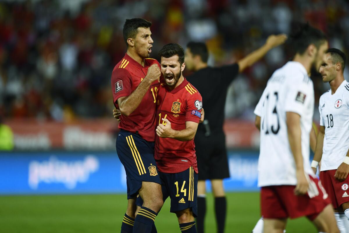 Spain's Jose Gaya, 2nd left, celebrates after scoring his side's opening goal during the World Cup 2022 group B qualifying soccer match between Spain and Georgia at the Nuevo Estadio Vivero in Badajoz, Spain, Sunday, Sept. 5, 2021. (AP Photo/Jose Breton)