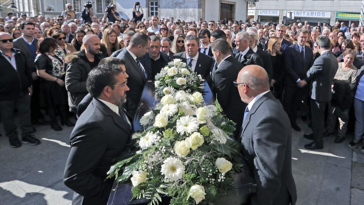 People attend the funeral for the two Spanish victims of the Easter Sunday bombings in Sri Lanka, in Pontecesures, Galicia, Spain, on Friday.