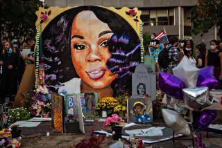People gather at a memorial for Breonna Taylor's in Injustice Square Park in downtown Louisville in 2020.