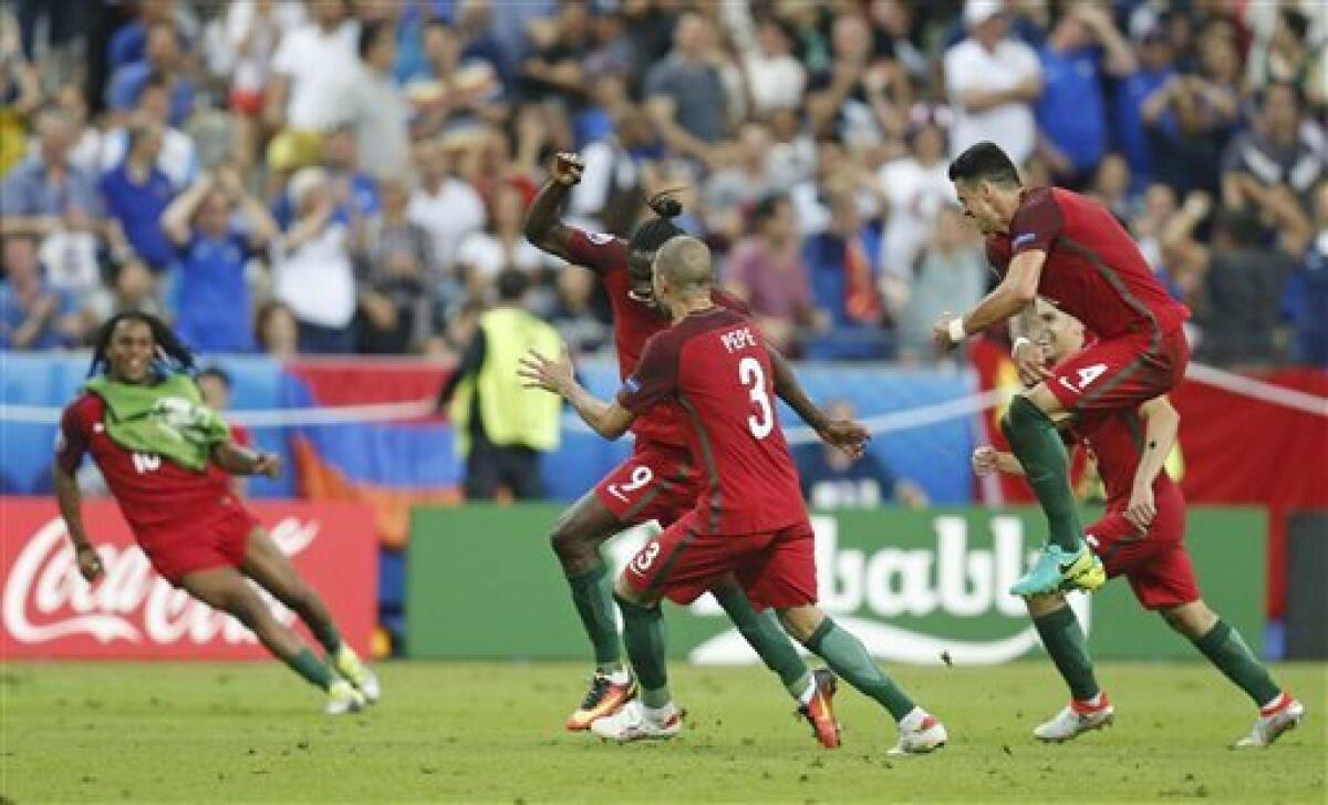 El jugador de Portugal, Eder, centro, festeja con compañeros tras anotar un gol contra Francia en la final de la Eurocopa el domingo, 10 de julio de 2016, en Saint-Denis, Francia. (AP Photo/Michael Probst)