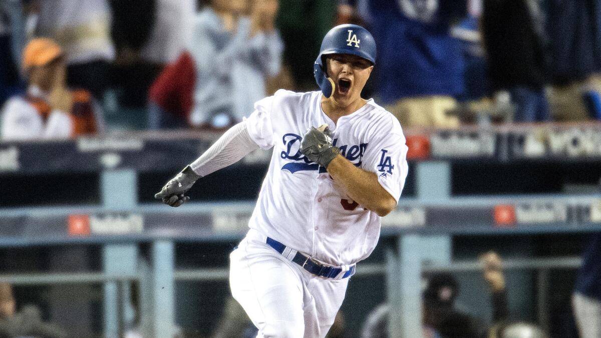 Dodgers center fielder Joc Pederson celebrates as he rounds the bases after hitting a solo homer to give Dodgers a 3-1 lead over the Astors during the seventh inning of Game 6.