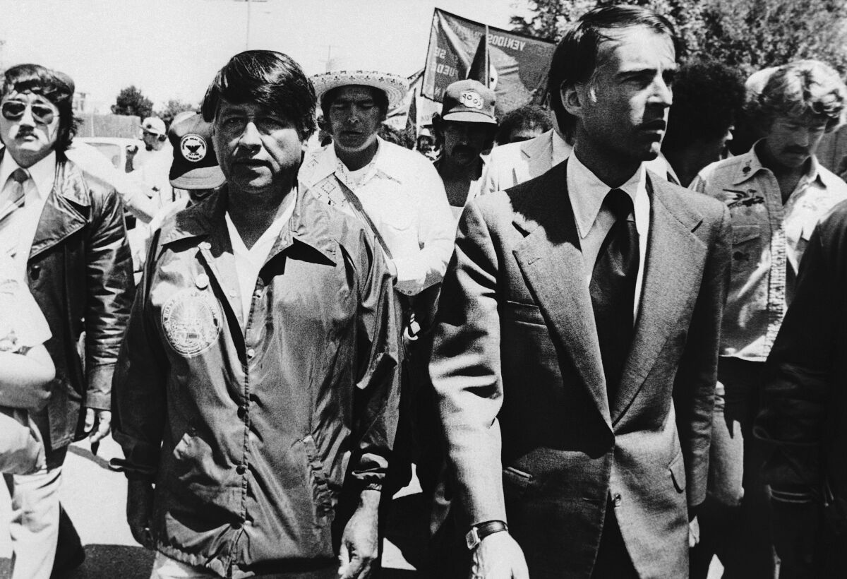 Gov. Edmund Brown Jr. walks next to Cesar Chavez as hundreds of farmworkers follow.