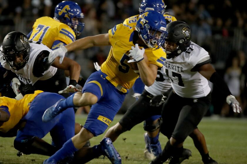 LA PUENTE, CALIF. - SEP 9, 2021. Bishop Amat running back Aiden Ramos makes a short gain against Servite on Thursday night, Sep. 9, 2021. (Luis Sinco / Los Angeles Times)