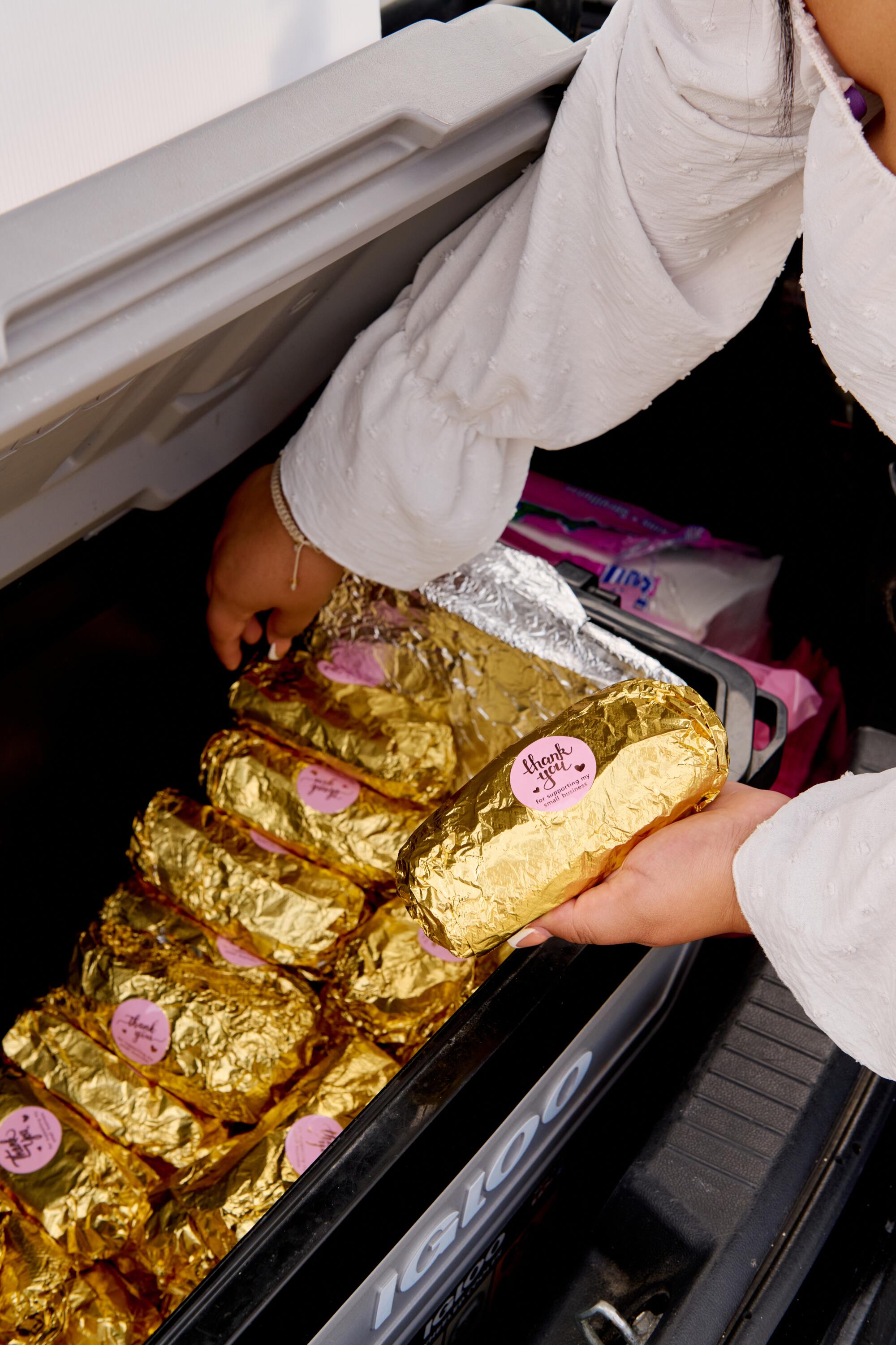 Maria Sanchez's foil -wrapped burritos are a cool in her car.