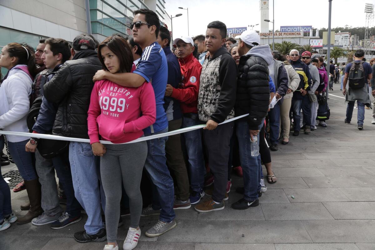 People line up to buy tickets to the first leg of the final Copa Libertadores matches between Ecuador's Independiente del Valle and Colombia's Atletico Nacional in Quito, Ecuador, Monday, July 18, 2016. The game is set for Wednesday. (AP Photo/Dolores Ochoa)