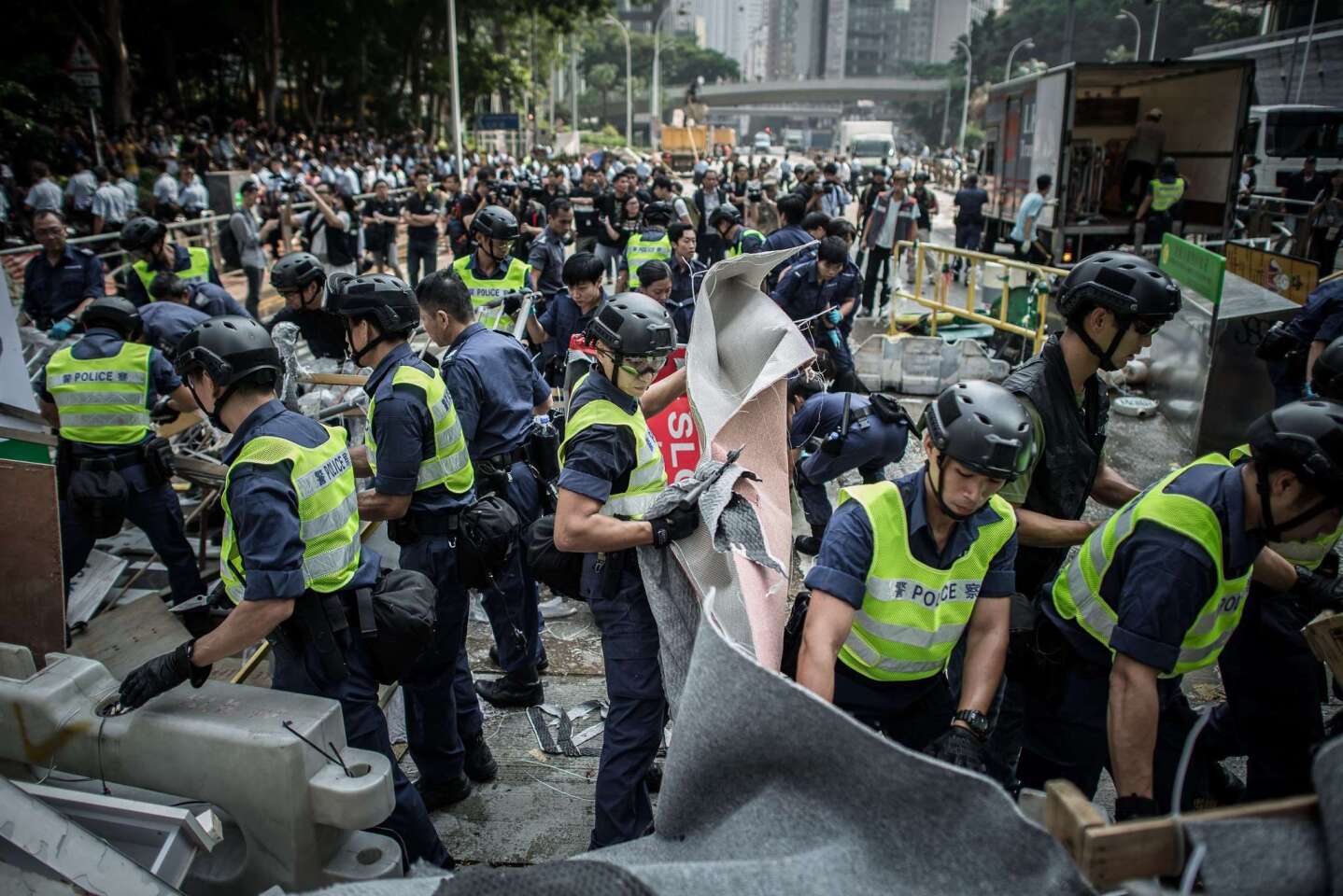 Police armed with bolt cutters, chainsaws and sledgehammers made a renewed attempt to remove barricades along a stretch of the main protest site held by pro-democracy demonstrators in Hong Kong on October 14, 2014.