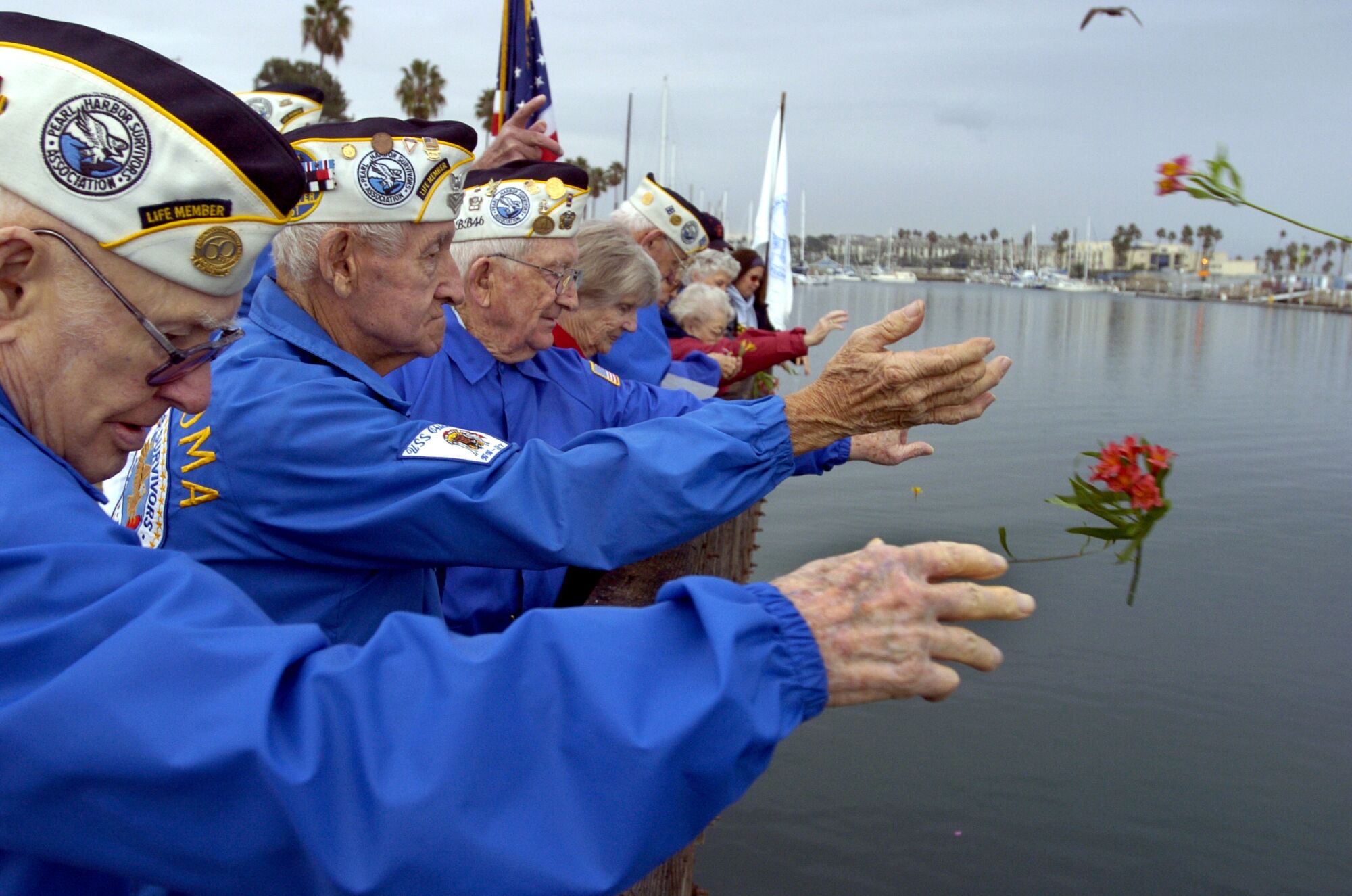 Members of the Pearl Harbor Survivors Association toss flowers into Oceanside Harbor in 2004