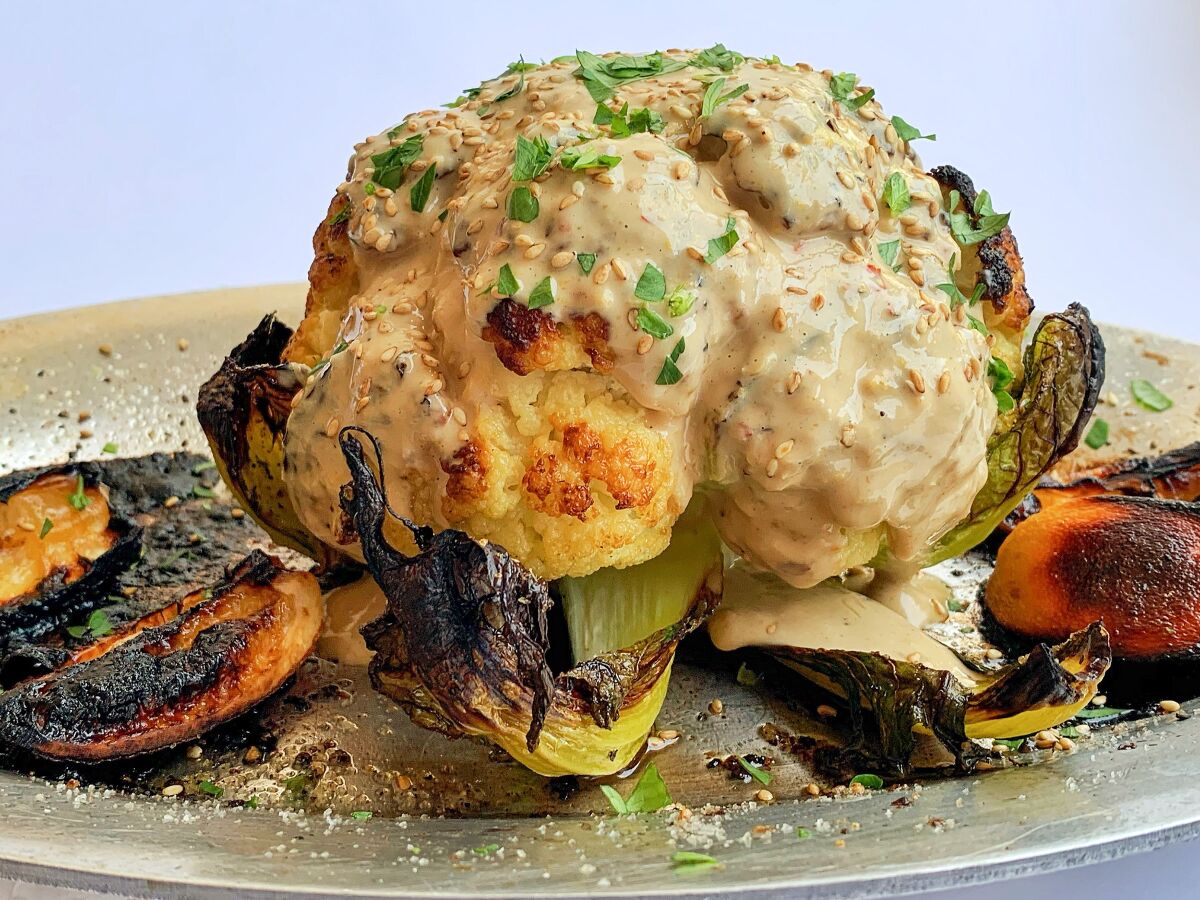 The most popular L.A. Times recipe of 2020 was this whole roasted cauliflower drenched in a spicy tahini sauce.