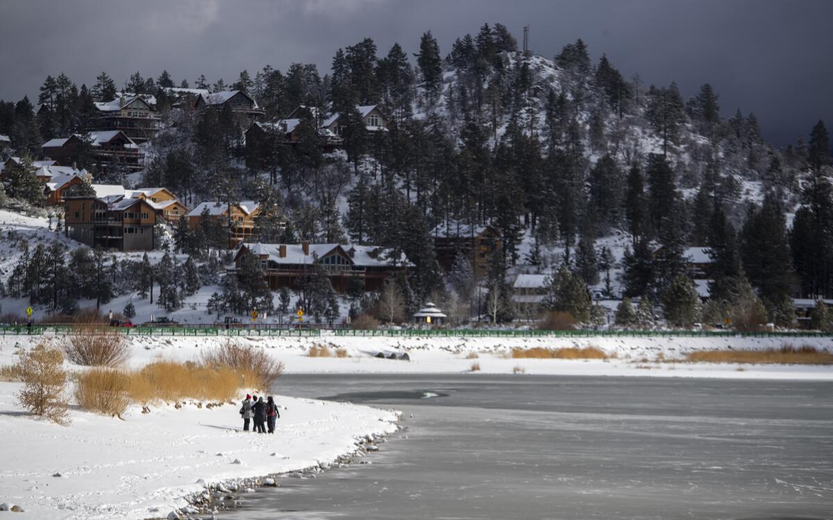 Residents and visitors walk the shore of Big Bear Lake after the first big storm of the year in December.