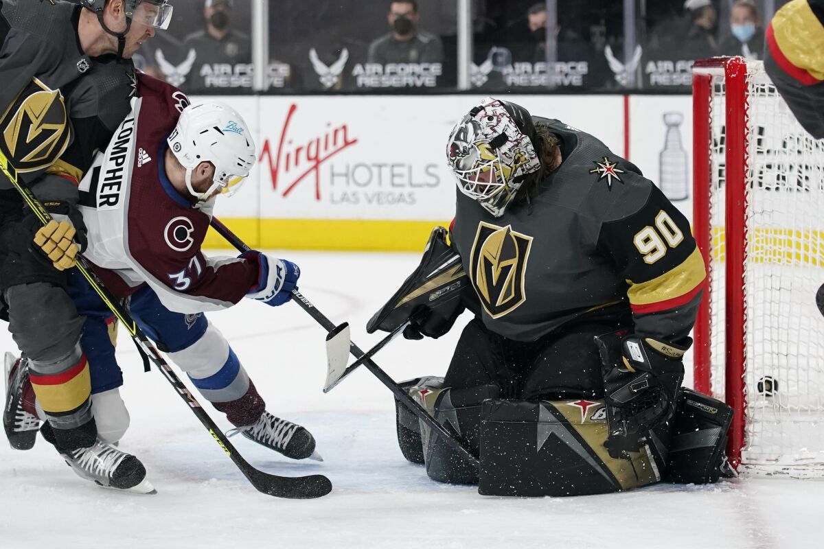 Colorado Avalanche left wing J.T. Compher (37) scores a goal against Vegas Golden Knights goaltender Robin Lehner (90) during the third period of an NHL hockey game Monday, May 10, 2021, in Las Vegas. (AP Photo/John Locher)