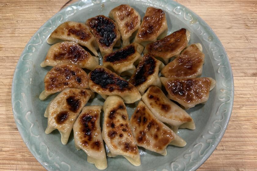 A platter of pan-fried pork dumplings.