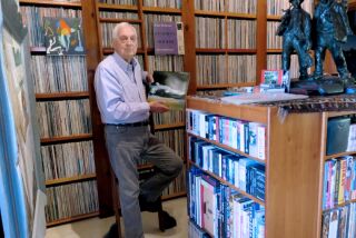 Bram Dijkstra is shown with part of his 50,000-strong collection of rare jazz.