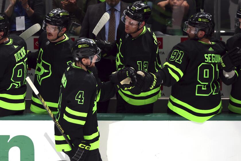 Dallas Stars defenseman Miro Heiskanen (4) fist bumps Tyler Seguin (91) after a goal against the Seattle Kraken during the third period in an NHL hockey game on Saturday, April 13, 2024, in Dallas. (AP Photo/Richard W. Rodriguez)