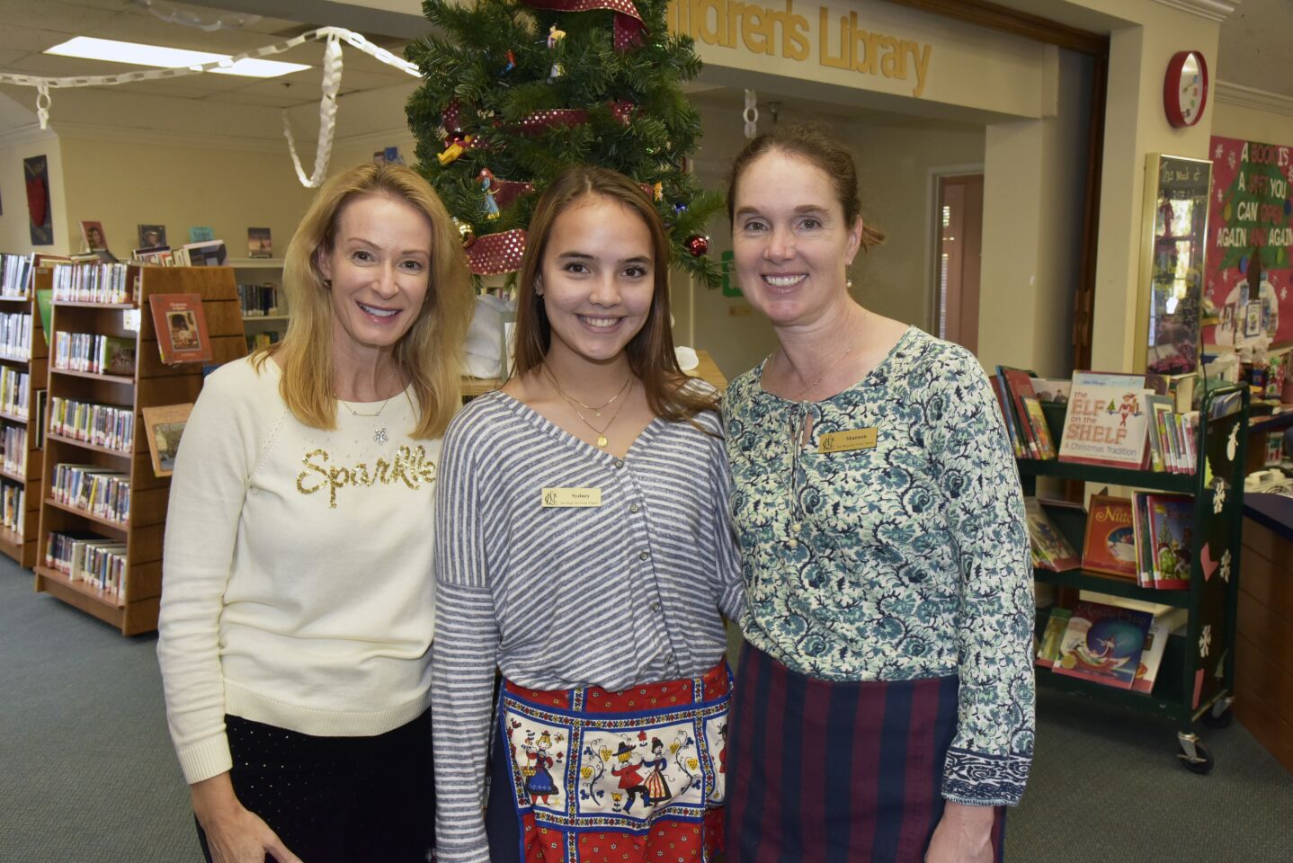 NCL Del Norte Chapter volunteer tree decorators Anna Waite (event co-chair), Sydney and her mom Shannon Nguyen