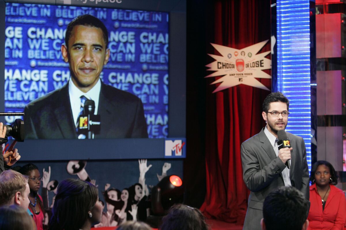 Barack Obama on a screen behind Gideon Yago at the MTV Studios in New York.