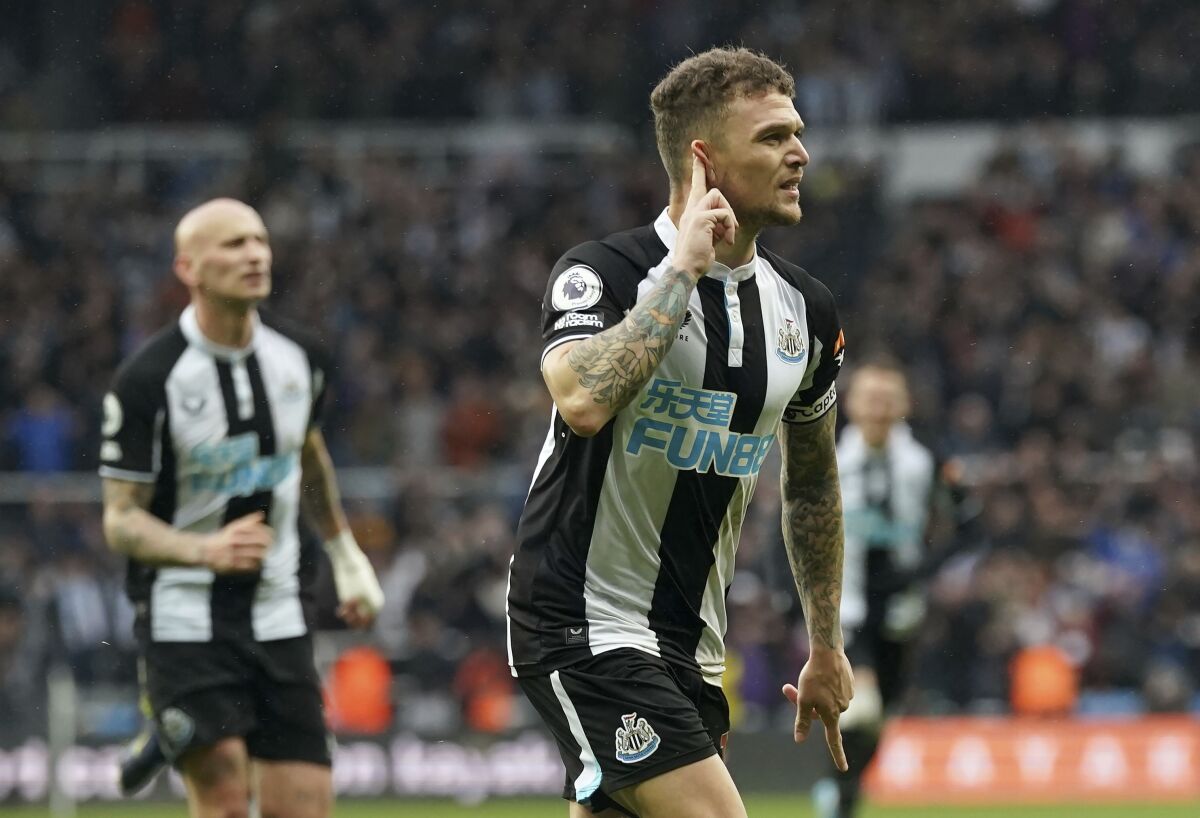 Newcastle United's Kieran Trippier celebrates scoring his side's first goal of the game from a free-kick, during the English Premier League soccer match between Newcastle United and Aston Villa, at St. James' Park, in Newcastle, England, Sunday, Feb. 13, 2022. (Owen Humphreys/PA via AP)
