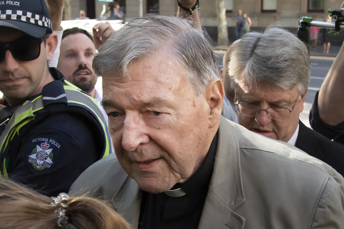 FILE - In this Feb. 27, 2019, file photo, Cardinal George Pell arrives at the County Court in Melbourne, Australia. A judge on Friday, June 4, 2021, ordered a dozen Australian media companies to pay fines from 1,000 Australian dollars ($766) to AU$450,000 ($345,000) for breaching a gag order by publishing references to Cardinal Pell's since-overturned convictions in 2018 for child sexual abuse. (AP Photo/Andy Brownbill, File)