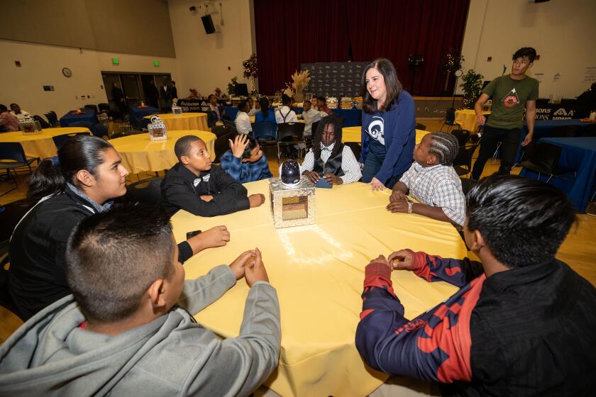 Molly Higgins is the RamsO VP for community engagement. She talks to kids at the Los Angeles Rams and Albertsons-Vons Pavilions host a Rams Family Thanksgiving dinner for players and coaches of the Watts Rams youth football program. As part of the effort, AVP will surprise each Watts Rams player with a $500 gift card to allow them to share the joy of Thanksgiving with their families. Each of the Watts Rams players will also receive two tickets to attend next weekOs Rams-Ravens Monday Night Football game presented by AVP. Tuesday, November 19, 2019, Watts, CA. (Will Navarro/Rams)