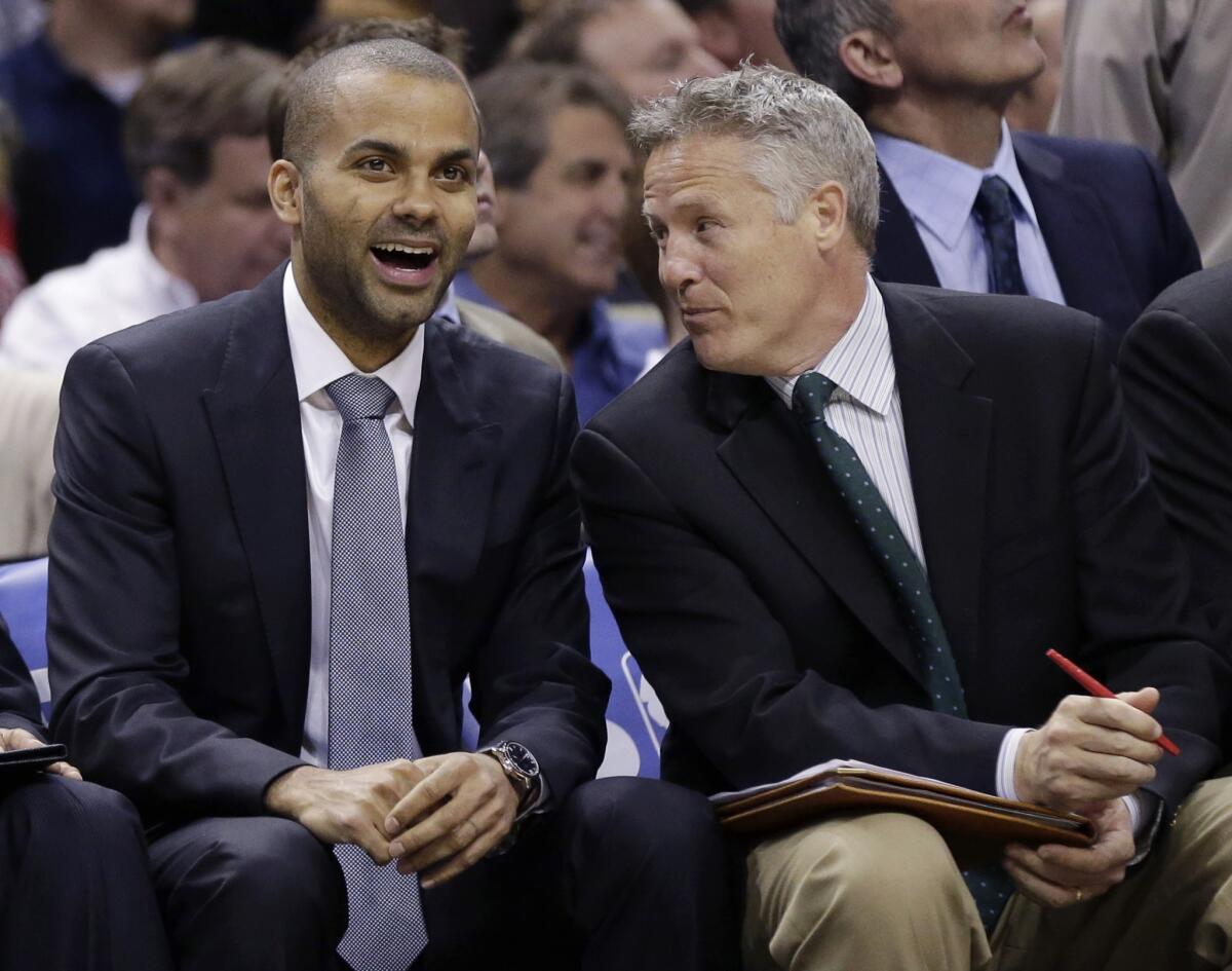 San Antonio Spurs assistant coach Brett Brown, right, speaks with guard Tony Parker during a game in March. The Philadelphia 76ers have hired Brown as their new head coach.