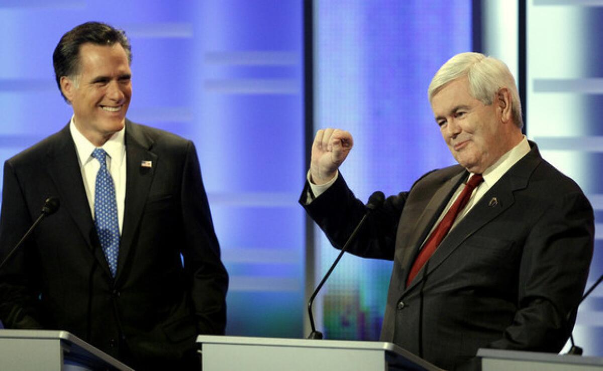 Mitt Romney, left, and Newt Gingrich take part in the Republican debate in Des Moines, Iowa.