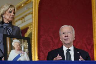 President Joe Biden signs a book of condolence at Lancaster House in London, following the death of Queen Elizabeth II, Sunday, Sept. 18, 2022, as first lady Jill Biden looks on. (AP Photo/Susan Walsh)