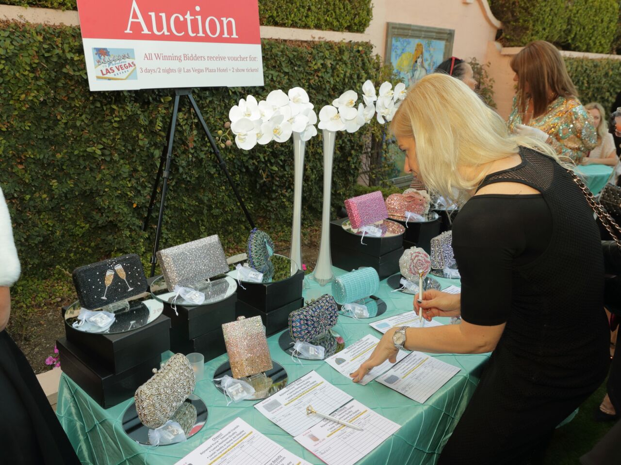 Guests review the silent auction items