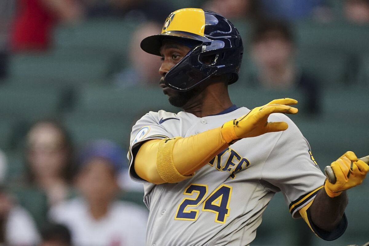 Milwaukee Brewers' Andrew McCutchen hits a single in the first inning of a baseball game against the Atlanta Braves, Friday, May 6, 2022, in Atlanta. (AP Photo/John Bazemore)
