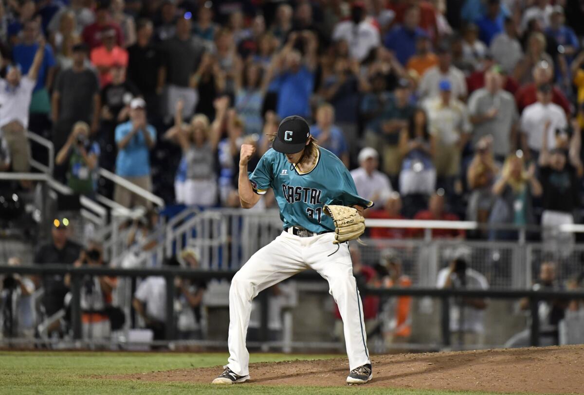 Coastal Carolina reliever Bobby Holmes reacts to the final out against Arizona in the ninth inning of Game 2 of the College World Series finals.