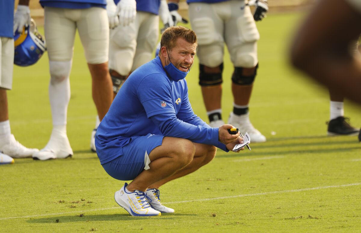Los Angeles Rams head coach Sean McVay works with players.