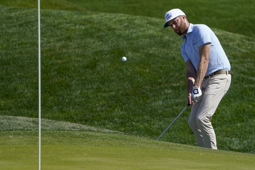 Chris Kirk chips to the green on the ninth hole during the second round of the The Players Championship golf tournament Friday, March 12, 2021, in Ponte Vedra Beach, Fla. (AP Photo/John Raoux)