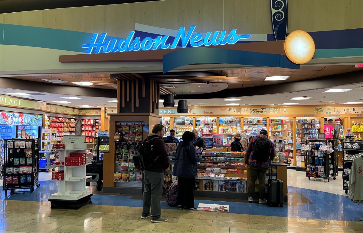 John Wayne Airport travelers line up at Hudson News, which operates under a concessionaire's agreement set to expire.