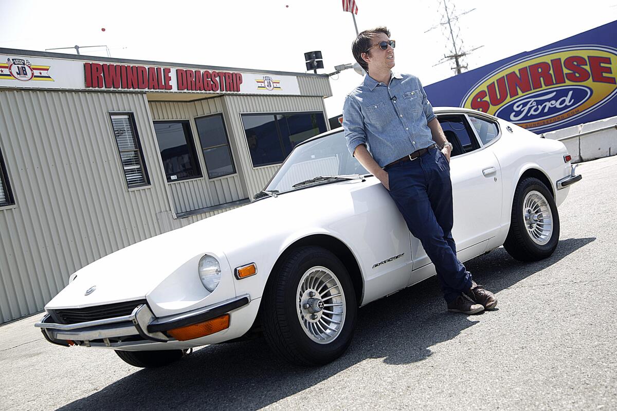 Times reporter Daniel Miller, who comes from three generations of car dealers, poses with his 1972 Datsun 240Z.