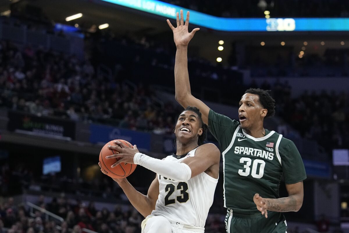 Purdue guard Jaden Ivey (23) shoots against Michigan State forward Marcus Bingham Jr. (30) during the first half of an NCAA college basketball game in the semifinal round at the Big Ten Conference tournament, Saturday, March 12, 2022, in Indianapolis. (AP Photo/Darron Cummings)