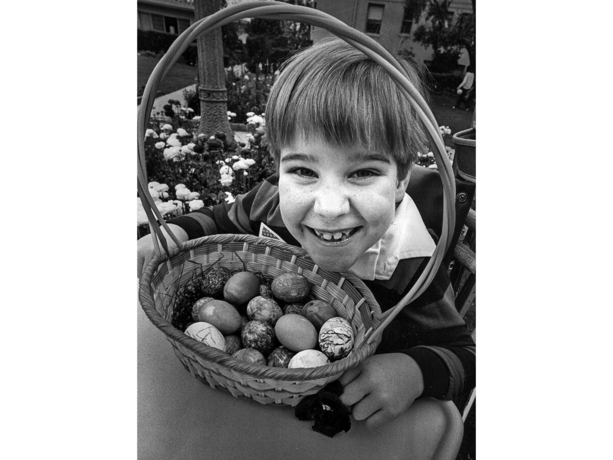 March 20, 1978: George Vick, 8, 1977 Poster Child for the Los Angeles Crippled Children's Society, has his basket of eggs following annual Easter Egg Hunt at the Ambassador Hotel.