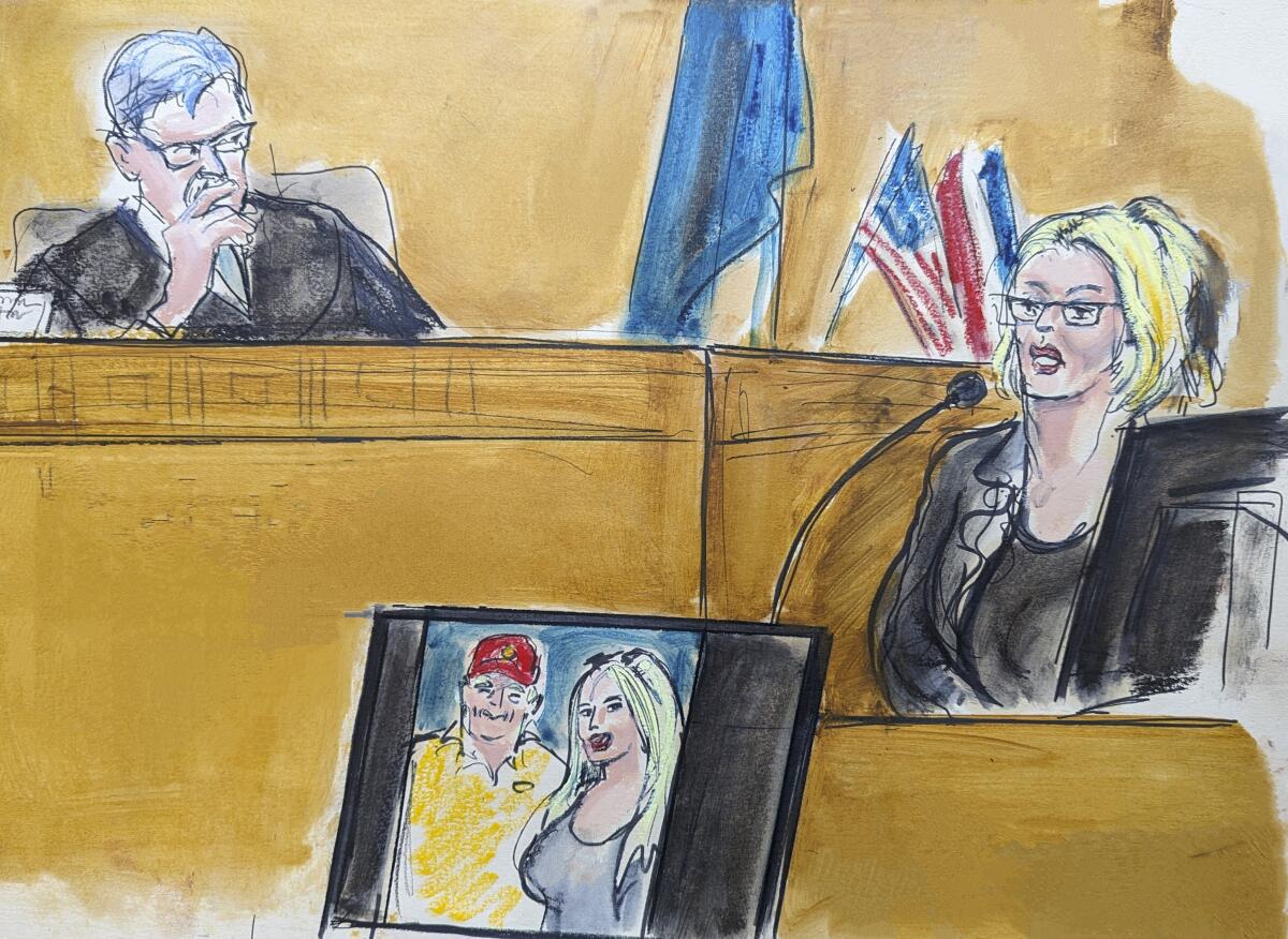A courtroom sketch of Stormy Daniels, Judge Juan Merchan and a displayed photo of Trump with Daniels.
