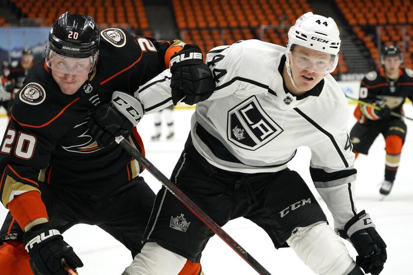 Anaheim Ducks left wing Nicolas Deslauriers, left, and Los Angeles Kings defenseman Mikey Anderson battle for the puck during the second period of an NHL hockey game Wednesday, March 10, 2021, in Anaheim, Calif. (AP Photo/Mark J. Terrill)
