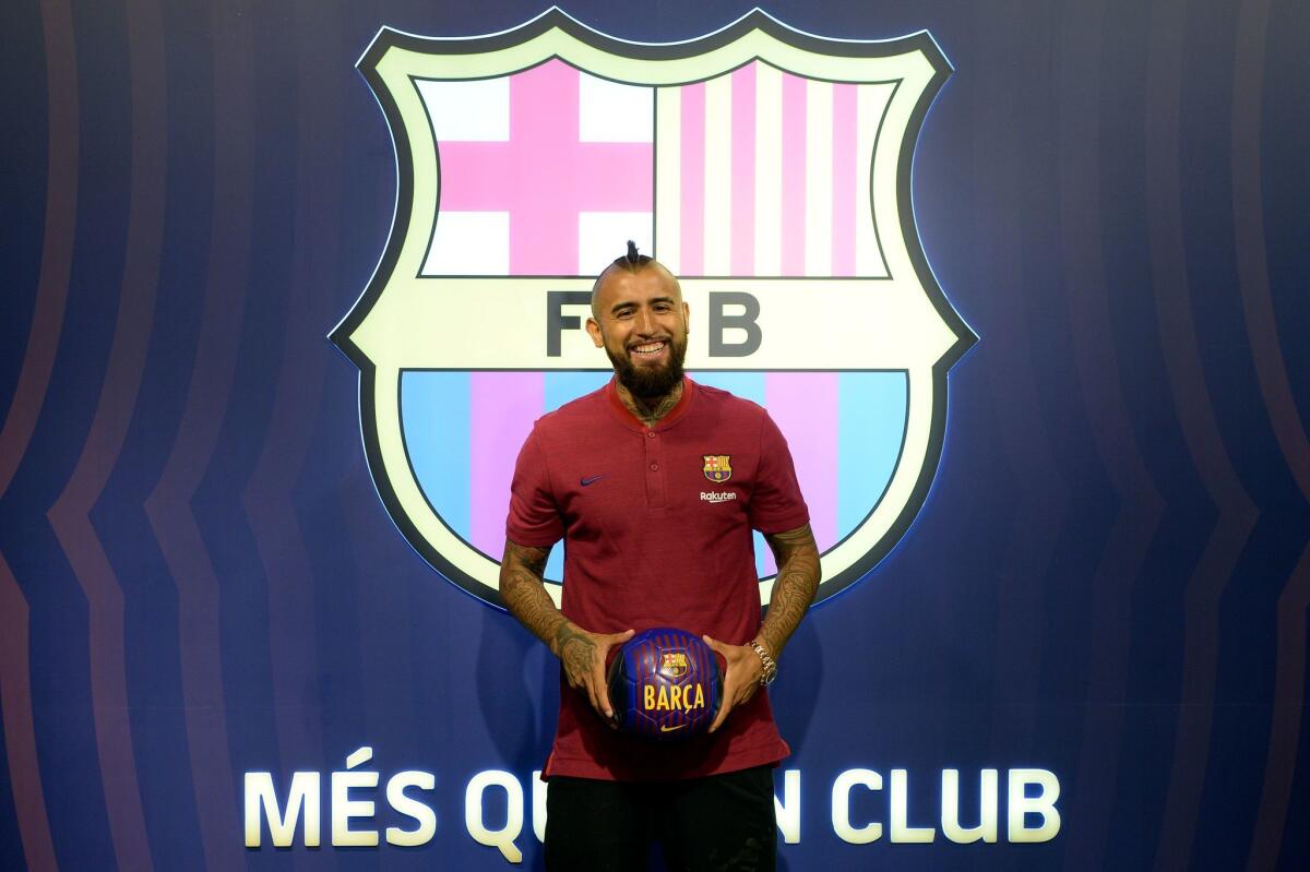 Former player of Bayern Munich football club, Arturo Vidal, poses at his new team's headquarters on August 5, 2018, one day after FC Barcelona announced an agreement with Bayern Munich to sign Chilean midfielder in a deal reportedly worth 30 million euros ($35 million).