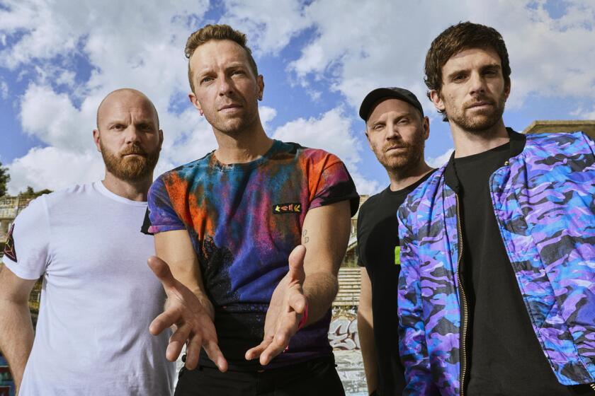 Will Champion, from left, Chris Martin, Jonny Buckland and Guy Berryman of Coldplay in a 2021 handout photo.